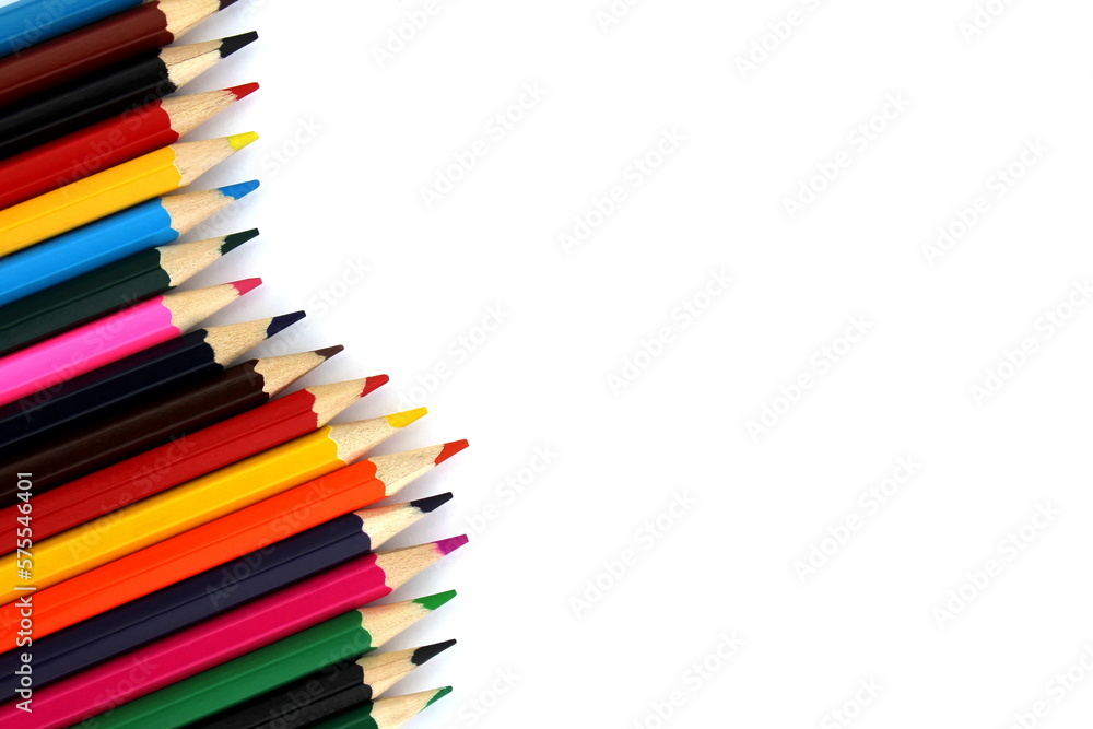 Bright colored pencils lie on a white background with space for text. Bright colored pencils lie on a white background with space for text.