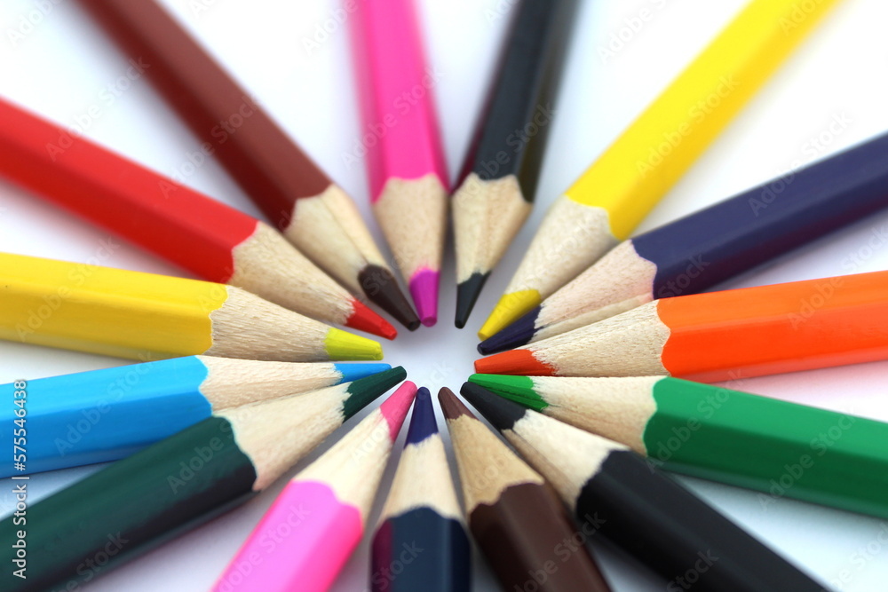Bright multi-colored pencils lie on a white isolated background. Bright multi-colored pencils lie on a white isolated background.