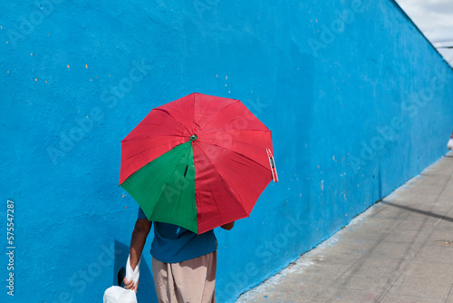 Cuban woman using an umbrella to repair herself from the strong tropical sun photo