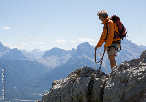 Mountaineer throws rope, mountain range photo