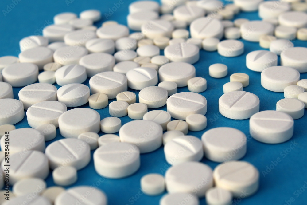 Abstract background of white pills on a blue background. Abstract background of white pills on a blue background.