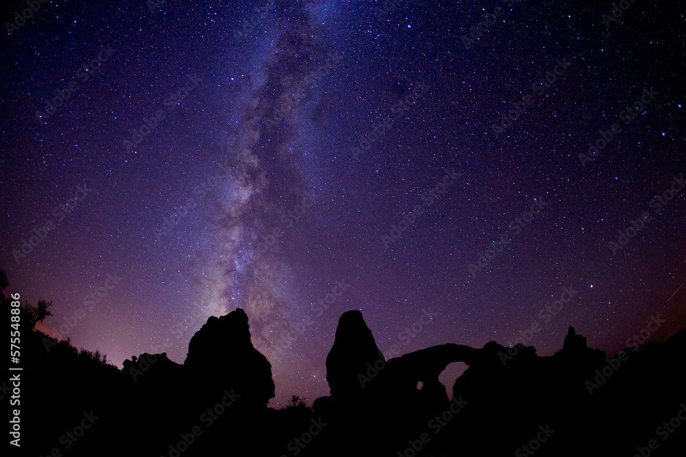 Milky is visible above majestic Arches National Park at night Milky is visible above majestic Arches National Park at night