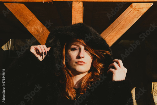 portrait of red-haired woman with hood photo