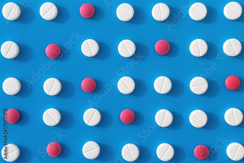 Abstract background of white pills on a blue background.