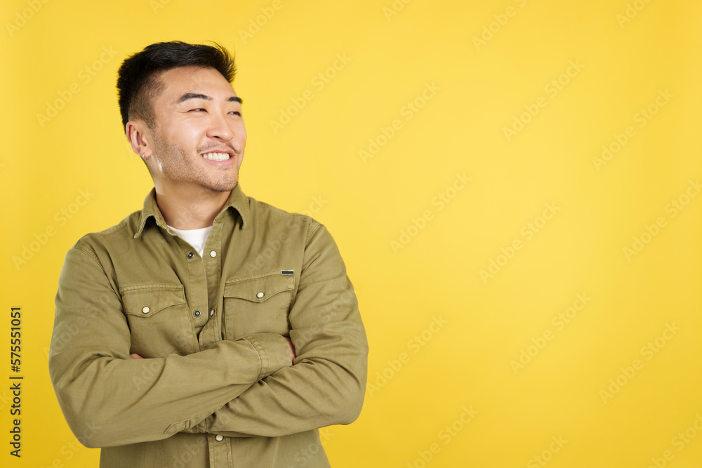 Chinese man smiling while looking to the side Chinese man smiling while looking to the side