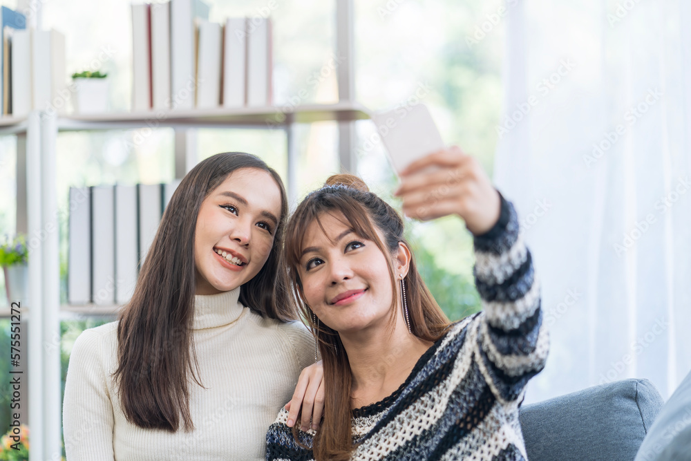 Lesbian Concept. Smiling beautiful Asian couple taking selfie. Couple doing self with mobile phone. Lesbian Concept. Smiling beautiful Asian couple taking selfie. Couple doing self with mobile phone.
