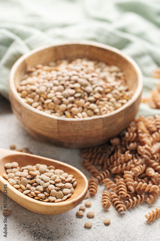 Green lentil fusilli pasta on a gray concrete background.