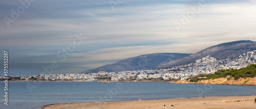 Fototapeta Naklejka Na Ścianę i Meble -  Athens, Greece. Panoramic view from Kavouri sandy beach of city building in front of mountain.