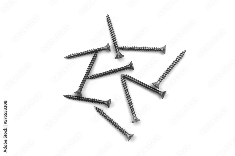 A lot of self-tapping screws lie on a white isolated background. A lot of self-tapping screws lie on a white isolated background.