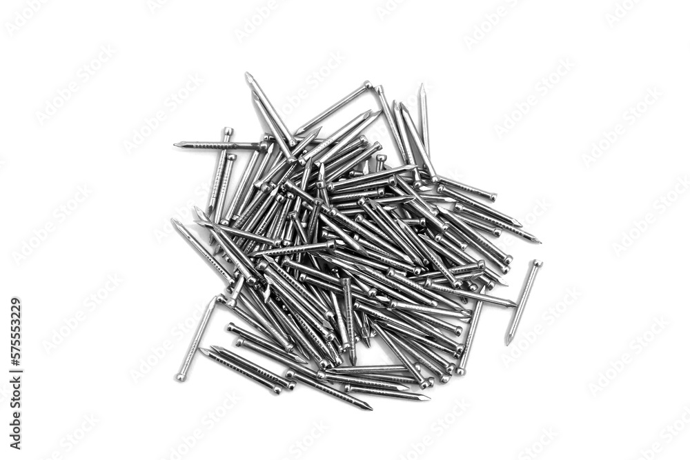 A pile of large iron nails lie on a white background A pile of large iron nails lie on a white background