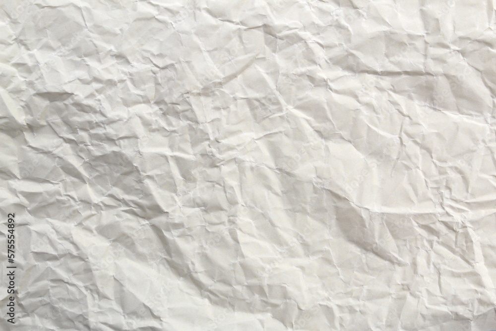 Fototapeta premium Soft crumpled sheet of light-colored paper. Abstract texture. 