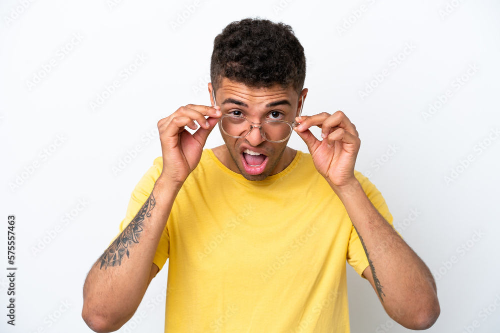 Young Brazilian man isolated on white background With glasses and frustrated expression Young Brazilian man isolated on white background With glasses and frustrated expression