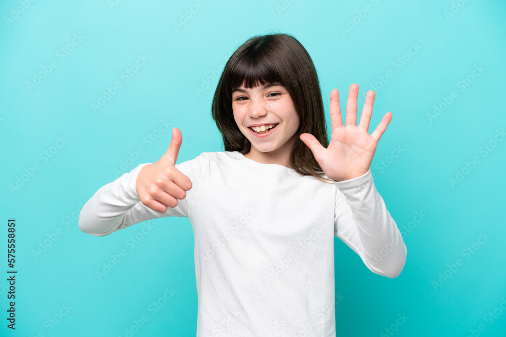 Little caucasian girl isolated on blue background counting six with fingers Little caucasian girl isolated on blue background counting six with fingers