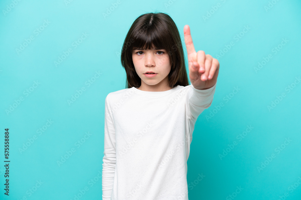 Little caucasian girl isolated on blue background counting one with serious expression Little caucasian girl isolated on blue background counting one with serious expression