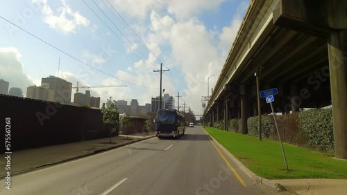 Point Of View A Big Commercial Bus Moving On Road Under Cloudy Sky In City - New Orleans, Louisiana