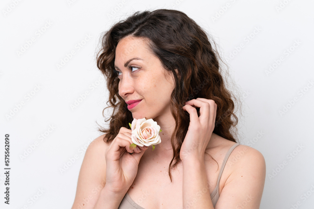 Young caucasian woman isolated on white background holding flowers. Close up portrait Young caucasian woman isolated on white background holding flowers. Close up portrait