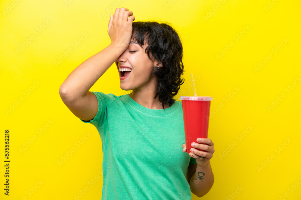 Young Argentinian woman holding a soda isolated on yellow background has realized something and intending the solution Young Argentinian woman holding a soda isolated on yellow background has realized something and intending the solution