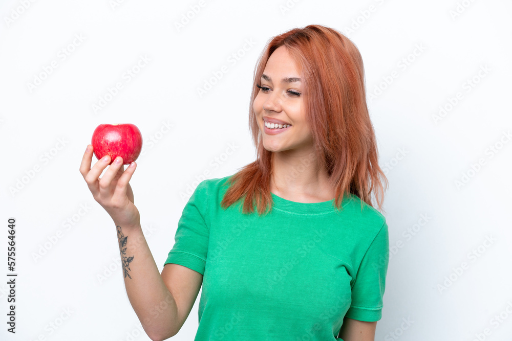 Young Russian girl with an apple isolated on white background with happy expression Young Russian girl with an apple isolated on white background with happy expression