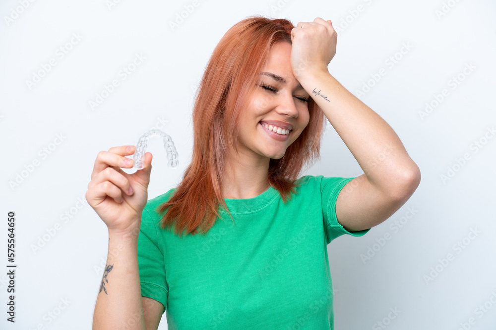 Young Russian girl holding invisible braces isolated on white background has realized something and intending the solution Young Russian girl holding invisible braces isolated on white background has realized something and intending the solution