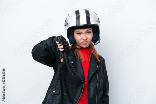 Young Russian girl with a motorcycle helmet isolated on white background showing thumb down with negative expression