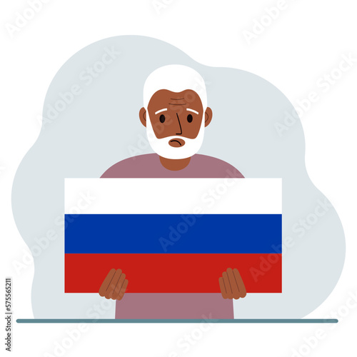 A man holds a Russian flag in his hands. The concept of demonstration, national holiday or patriotism. Nationality.