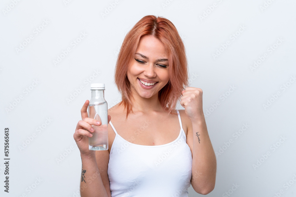 Young Russian girl with a bottle of water isolated on white background celebrating a victory Young Russian girl with a bottle of water isolated on white background celebrating a victory
