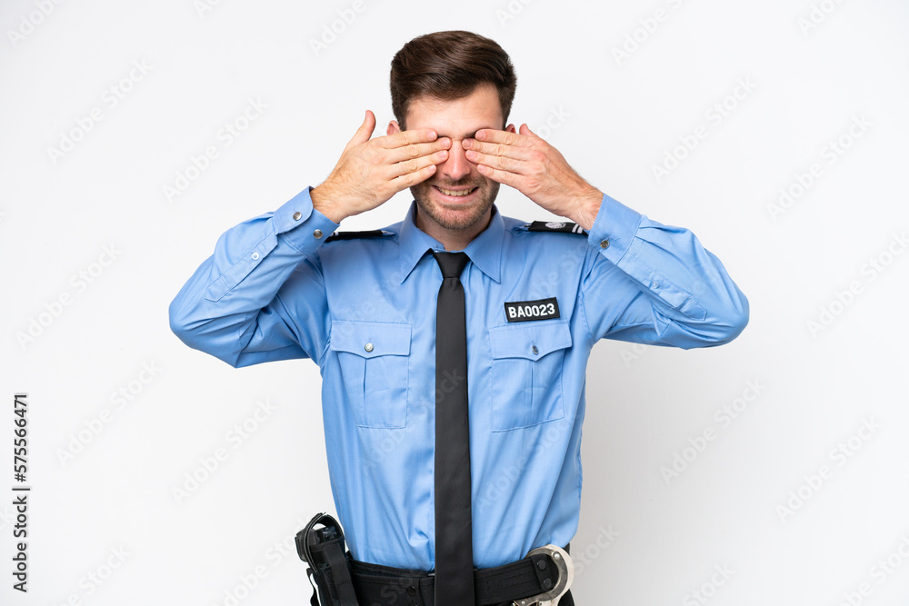 Young police caucasian man isolated on white background covering eyes by hands Young police caucasian man isolated on white background covering eyes by hands