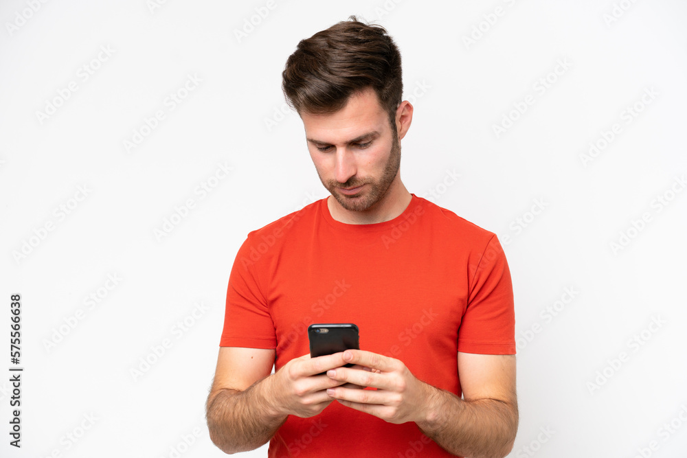 Young caucasian man isolated on white background using mobile phone Young caucasian man isolated on white background using mobile phone