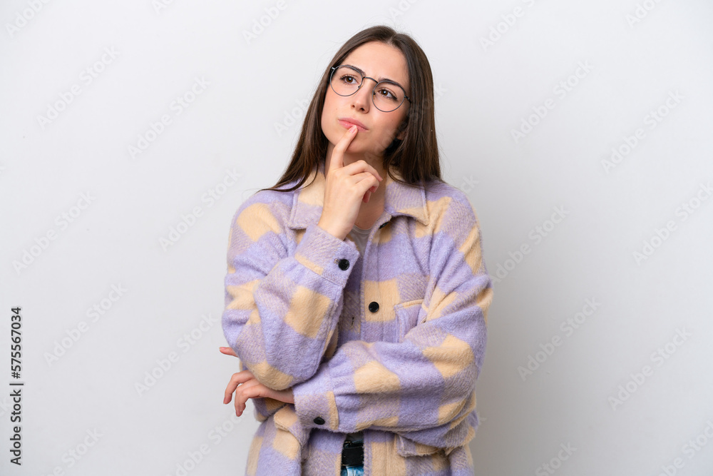 Young girl isolated on white background having doubts while looking up Young girl isolated on white background having doubts while looking up