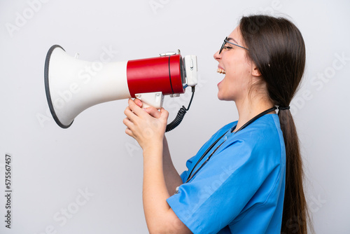 surgeon doctor woman holding tools isolated on white background shouting through a megaphone