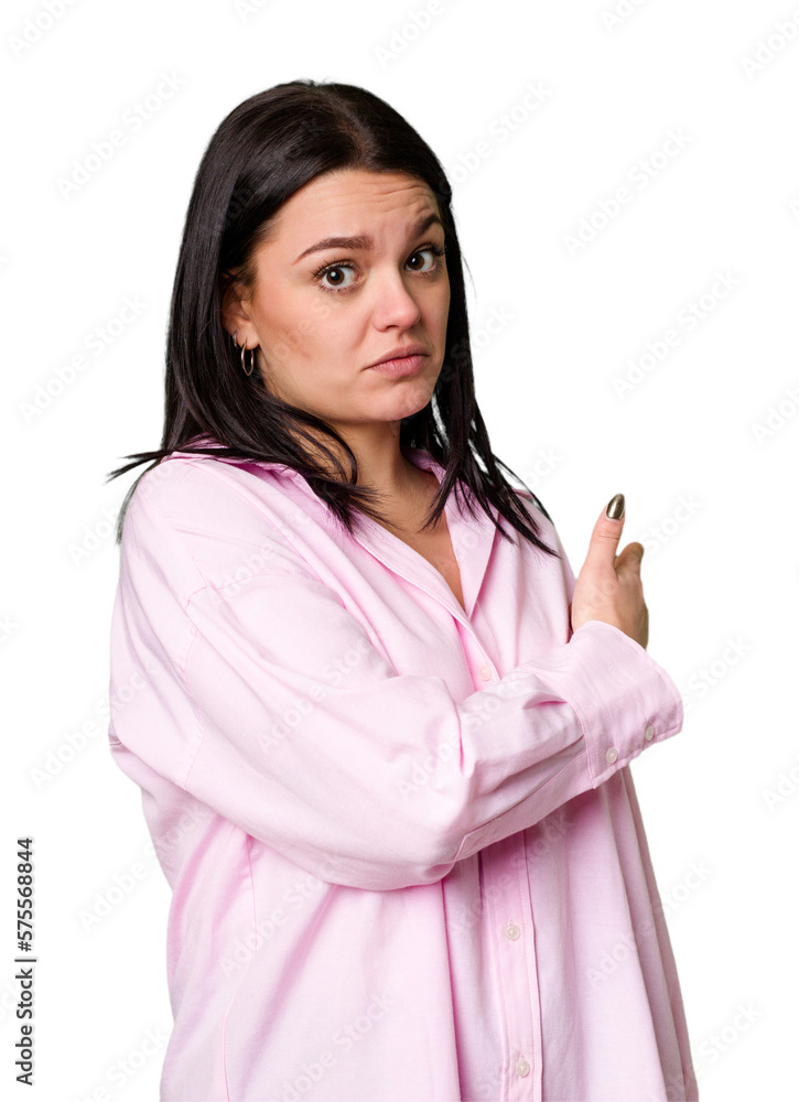 Young caucasian woman isolated smiling and pointing aside, showing something at blank space. Young caucasian woman isolated smiling and pointing aside, showing something at blank space.