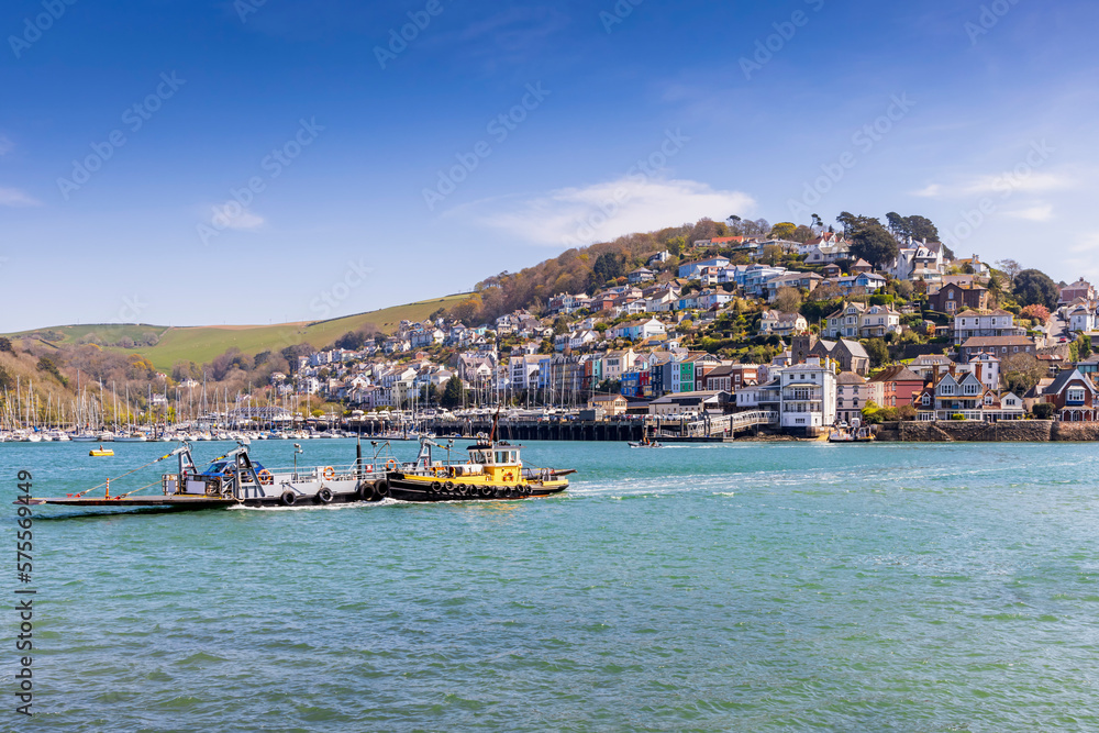 The Dartmouth to Kingswear lower car ferry crossing the River Dart in Devon, with the picturesque village of Kingswear in the background.