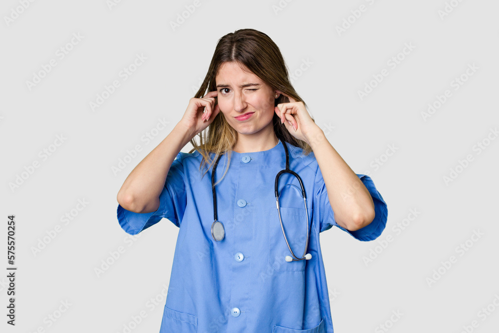 Young female nurse in uniform with stethoscope, symbol of care and dedication to patients confused, feels doubtful and unsure. Young female nurse in uniform with stethoscope, symbol of care and dedication to patients confused, feels doubtful and unsure.