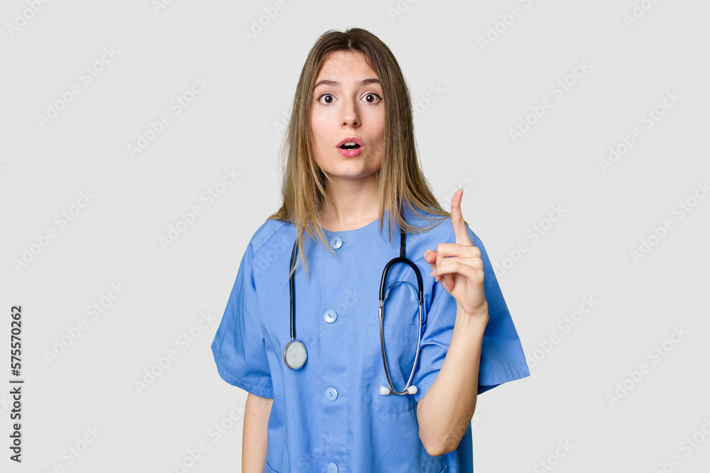 Young female nurse in uniform with stethoscope, symbol of care and dedication to patients biting fingernails, nervous and very anxious.