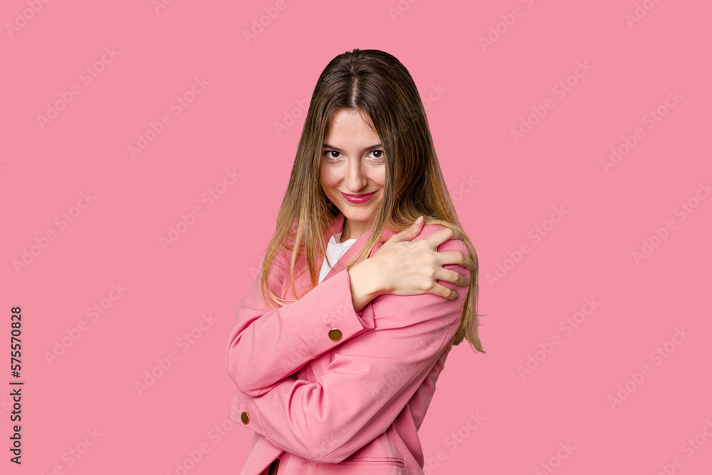 Young blonde posing for a portrait isolated, exuding natural beauty and radiance hugs, smiling carefree and happy. Young blonde posing for a portrait isolated, exuding natural beauty and radiance hugs, smiling carefree and happy.