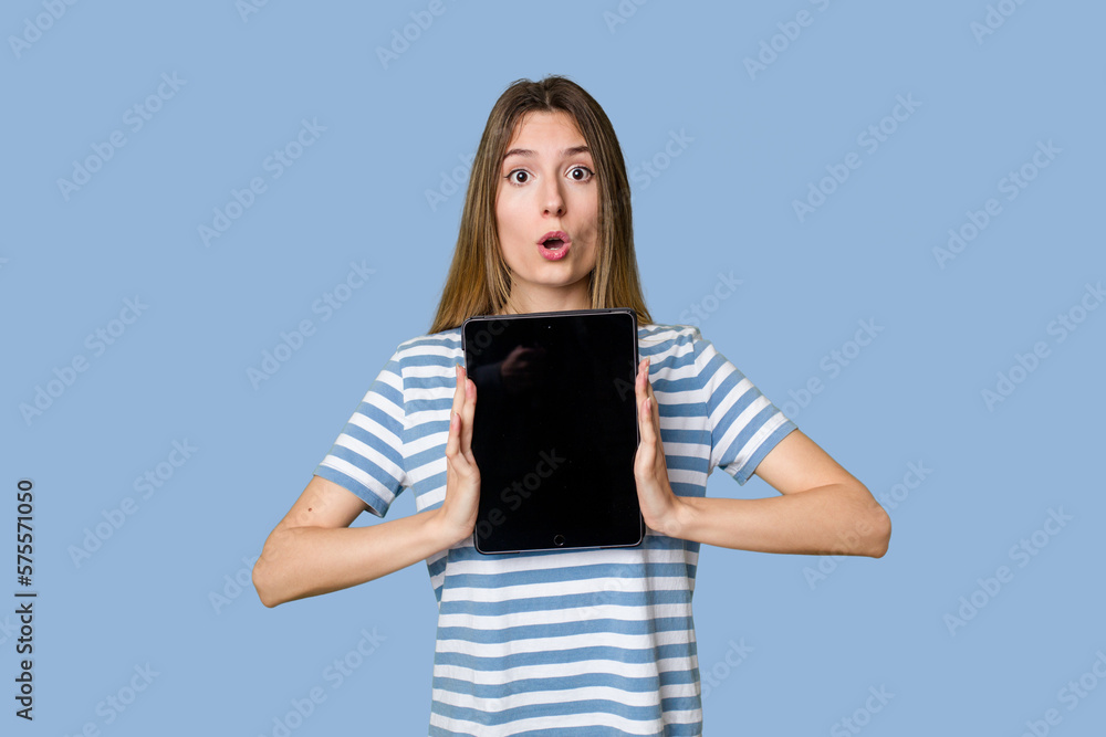 A beautiful young woman displays a sleek tablet, showcasing her tech-savvy and modern style. A beautiful young woman displays a sleek tablet, showcasing her tech-savvy and modern style.