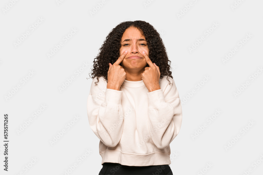 Young african american curly woman isolated crying, unhappy with something, agony and confusion concept. Young african american curly woman isolated crying, unhappy with something, agony and confusion concept.