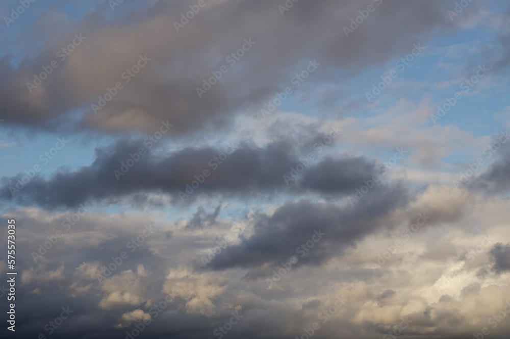 grey and white clouds on blue sky background. Storm is coming