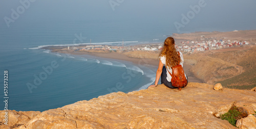 Woman tourist looking at Morocco coast- Imsouane photo