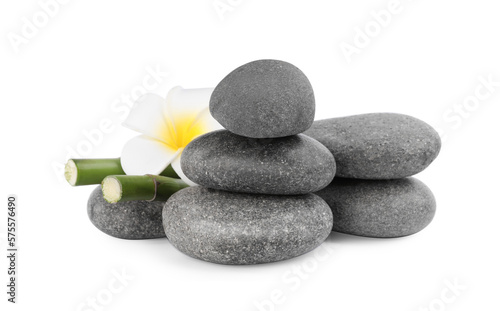 Spa stones with flower and bamboo stems isolated on white