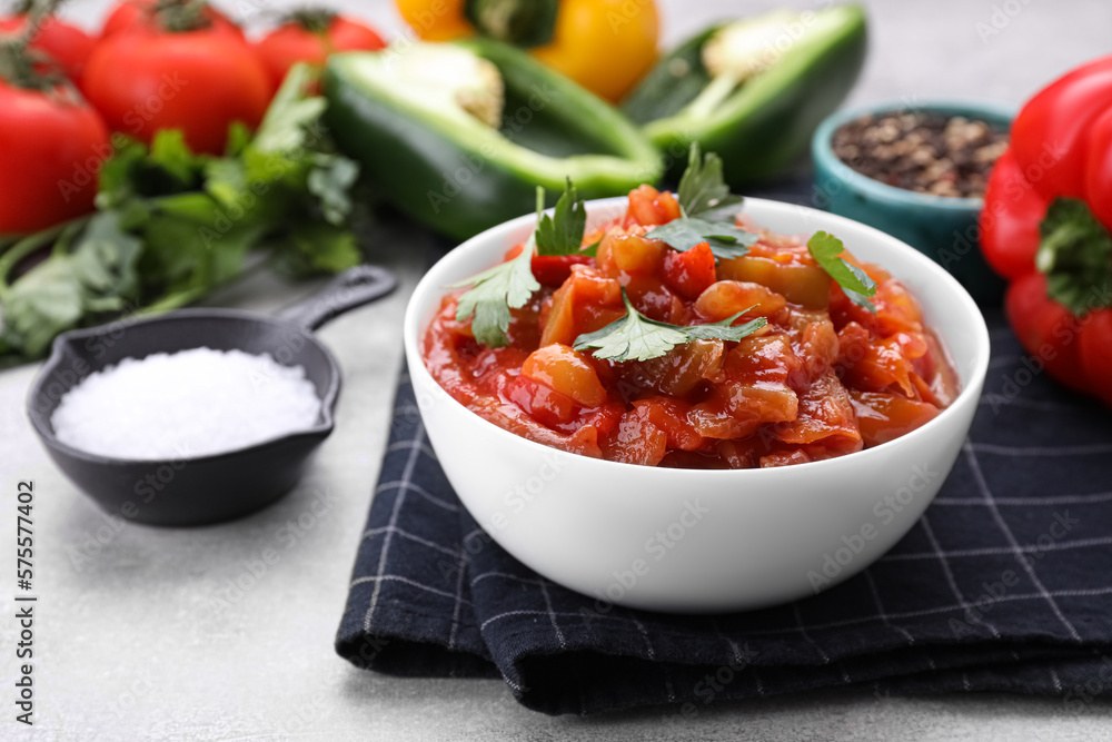 Delicious lecho with parsley in bowl on table, closeup Delicious lecho with parsley in bowl on table, closeup