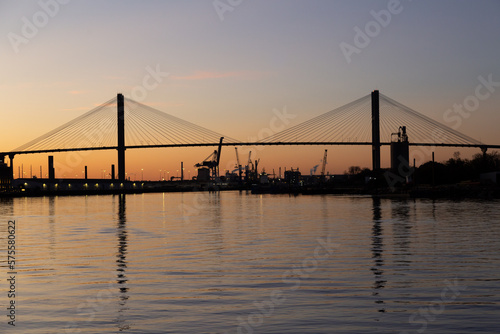 The  1991 cable-stayed Talmadge Memorial Bridge over the Savannah River seen in silhouette during a golden hour sunset
