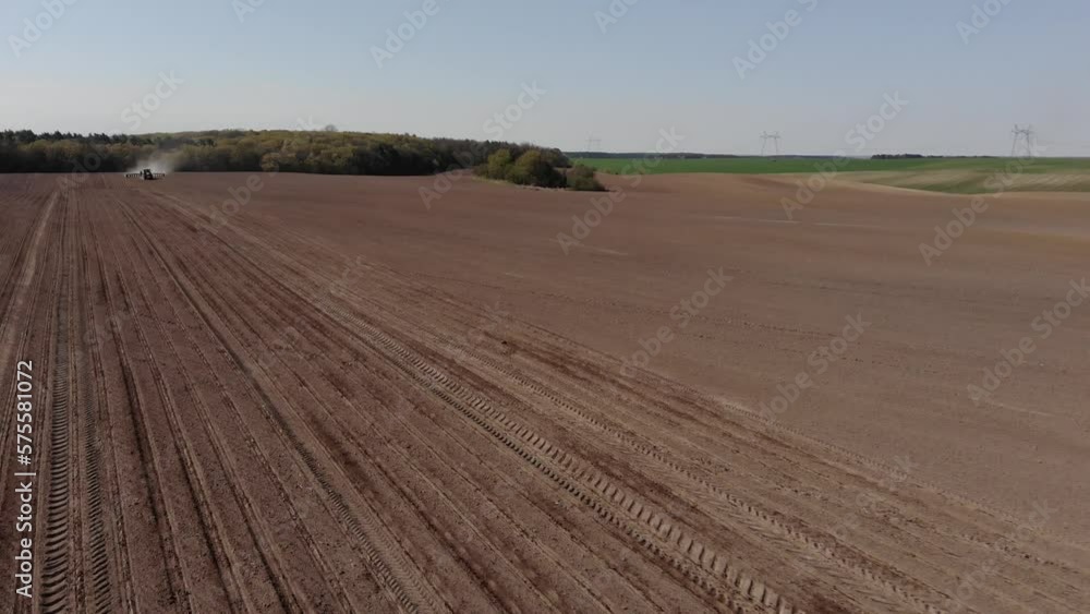 Green tractor planting sunflower on the sandy field in Ukraine 4K Green tractor planting sunflower on the sandy field in Ukraine 4K