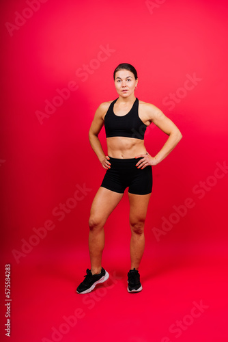 Cool female fighter in boxing bandages trains in studio. Mixed martial arts. © Ivan Zelenin