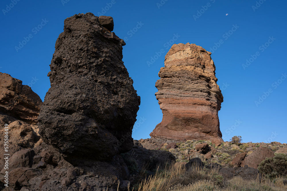 View of Los Roques de Garcia,  Tenerife, Canary islands, Spain, Europe. Rocky mountains with blue sky and the moon in the background. 
