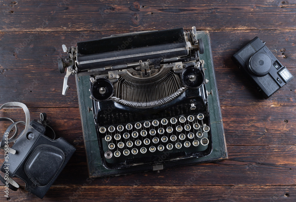 old tipywriter with old camera on wooden background old tipywriter with old camera on wooden background
