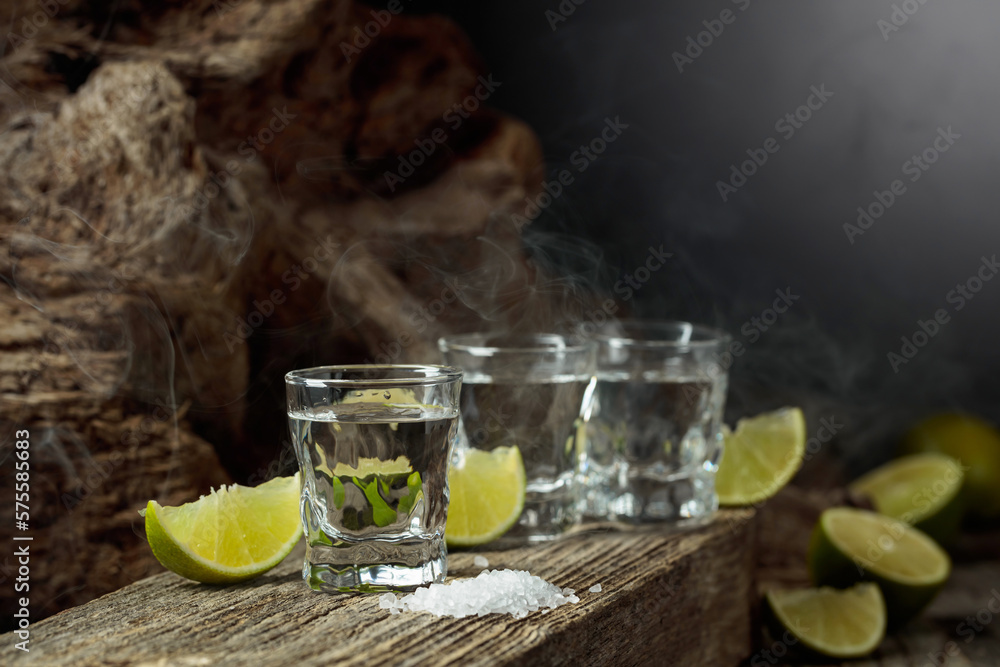 Tequila with salt and lime slices.