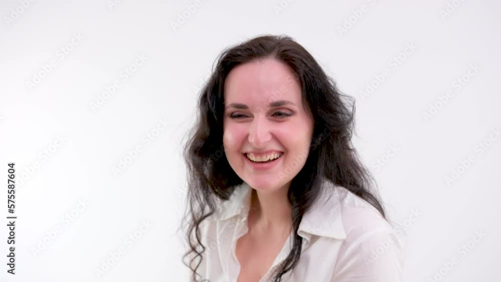 Young brunette woman opened her mouth put her hands to her face and screams with joy laughs Looking at camera charming smile scream happy rejoices winner. People sincere emotions lifestyle concept Young brunette woman opened her mouth put her hands to her face and screams with joy laughs Looking at camera charming smile scream happy rejoices winner. People sincere emotions lifestyle concept