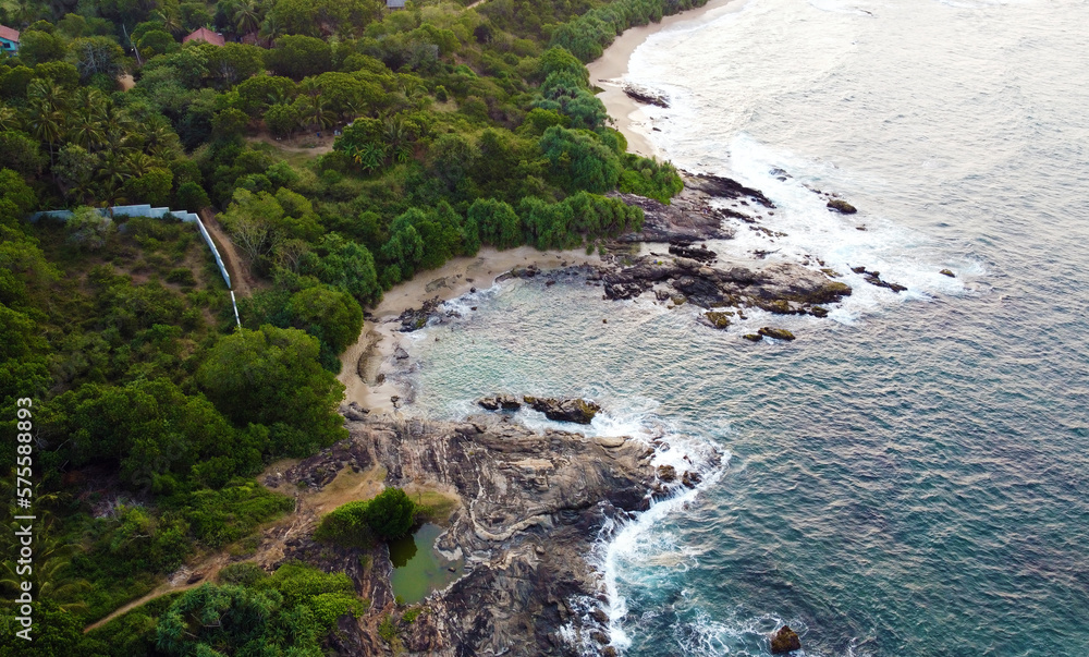 Obraz premium Aerial view of the tropical ocean landscape with a beach. Beautiful southern sea wallpaper for tourism and advertising. Asian landscape, drone photo