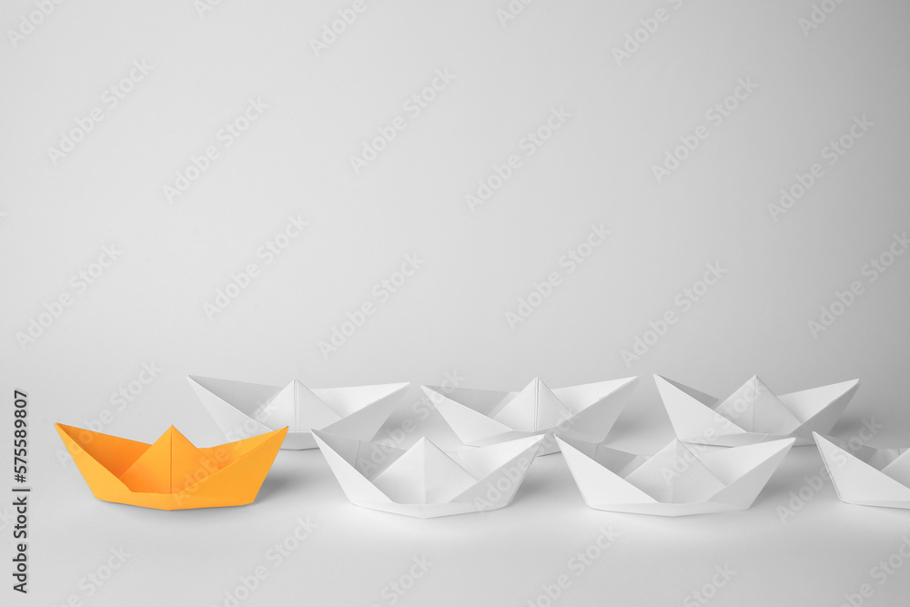 Group of paper boats following orange one on white background, space for text. Leadership concept Group of paper boats following orange one on white background, space for text. Leadership concept